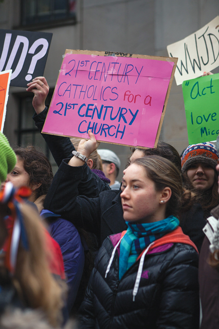 Students from Seattle Catholic schools join with other pro-LGBT demonstrators at a rally in front of the Archdiocese of Seattle to protest the firing of vice principal Mark Zmuda for marrying his same-sex partner. © ALEX GARLAND/DEMOTIX/CORBIS