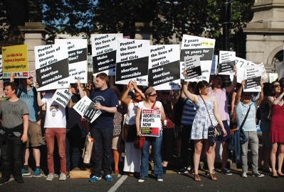 Prochoice supporters demonstrate in front of the gates of the Irish Parliament building in Dublin in July, just before the new abortion legislation was approved.