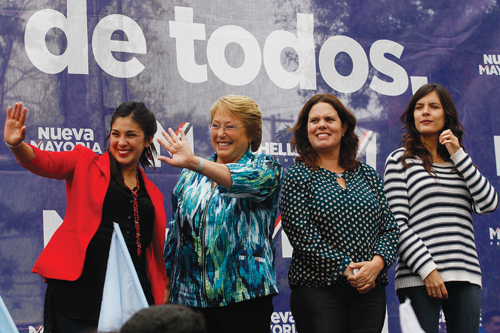 Chile’s president Michelle Bachelet, second left, is pictured during a campaign rally in 2013 with newly elected members of Congress Karol Cariola, left, granddaughter of former president Salvador Allende; Maya Fernandez, second right; and former student leader Camila Vallejo, right. 