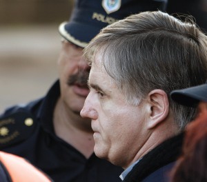 Police escort Argentinean priest Julio Cesar Grassi. 