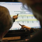 Visitors check the ballot results at the Crowne Plaza Albuquerque Hotel in Albuquerque, NM.